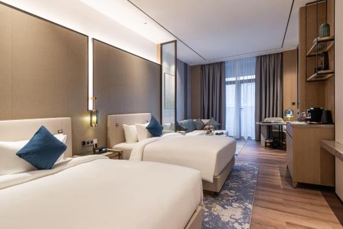 a hotel room with two beds and a kitchen at Braira Abha Hotel فندق بريرا أبها in Abha