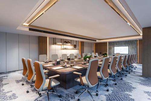 a conference room with a long table and chairs at Braira Abha Hotel فندق بريرا أبها in Abha