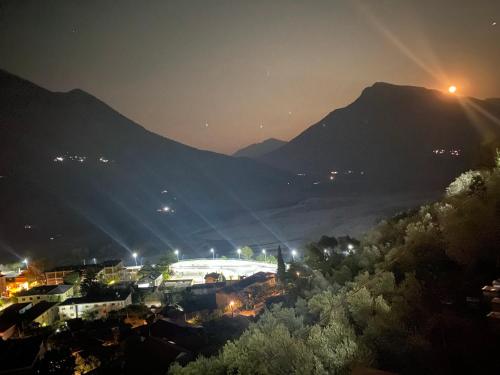 a soccer field at night with mountains in the background at Vila Përmbi Tepelenë in Tepelenë