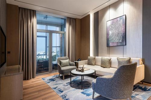 a living room with a couch and two chairs and a table at Braira Abha Hotel فندق بريرا أبها in Abha