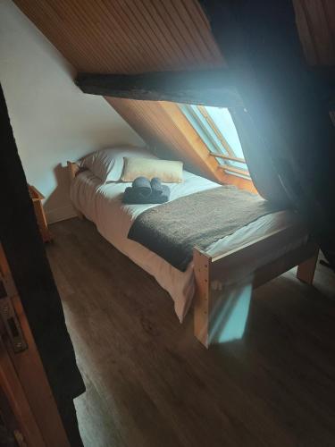 a bedroom with two beds in a attic at Le p'tit Palais in Le Palais