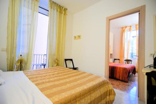 a hotel room with a bed and a window at Affittacamere Agata Levanto in Levanto