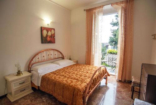 a bedroom with a bed and a large window at Affittacamere Agata Levanto in Levanto