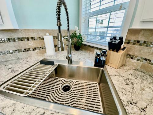 a stainless steel sink in a kitchen with a window at Intracoastal Breezes N1173 in Jensen Beach