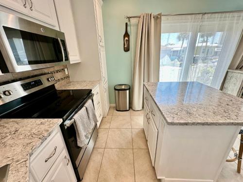 a kitchen with a stove and a counter top at Intracoastal Breezes N1173 in Jensen Beach