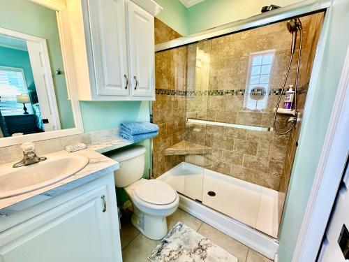 a bathroom with a toilet and a shower and a sink at Intracoastal Breezes N1173 in Jensen Beach