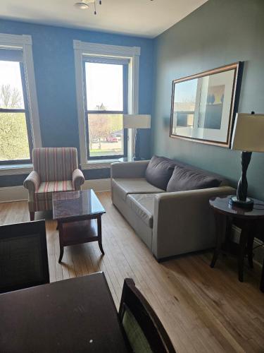 a living room with a couch and a chair at Albany Merchants Hotel in Albany