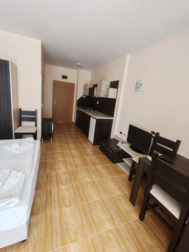 a room with a bed and a desk with a laptop at Magic Dreams Apartments in Sveti Vlas