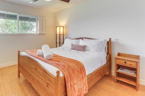 a bedroom with a bed with a wooden frame and a window at 3 Mi to Dtwn Shops and Eats Mesa Home with Pool! in Mesa