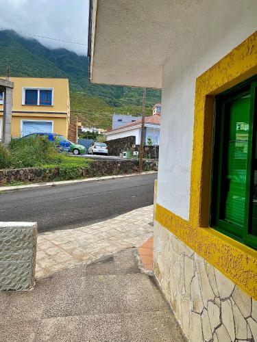 a building with a window on the side of a street at ApKanariooo in Frontera