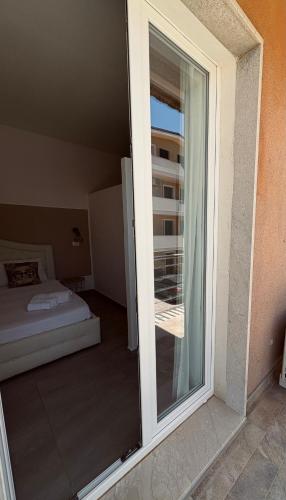 a sliding glass door to a bedroom with a balcony at Villa Joseph in Marzamemi