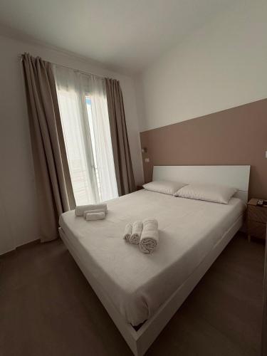 a bedroom with a bed with two towels on it at Villa Joseph in Marzamemi
