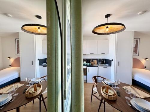 - une salle à manger avec une table, des chaises et deux lumières dans l'établissement We Live Inn Sharies Reims - A605, à Reims