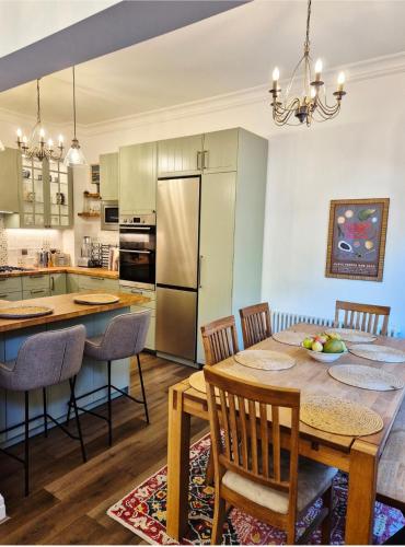a kitchen and dining room with a table and chairs at Coach House Greenwich in London