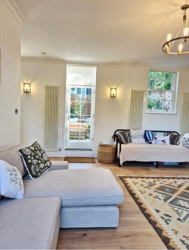 a living room with two beds and a couch at Coach House Greenwich in London