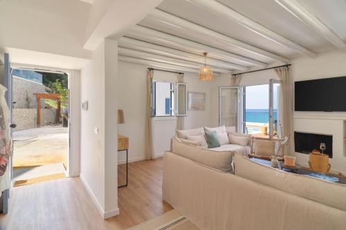 a living room with a couch and a view of the ocean at Villa Paradise Coastal Calm at Moonlight Villas in Pachyammos