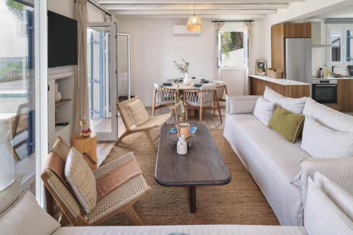 a living room with a couch and a table at Villa Astrofegia Moonlit Escape with Sea Views in Pachyammos