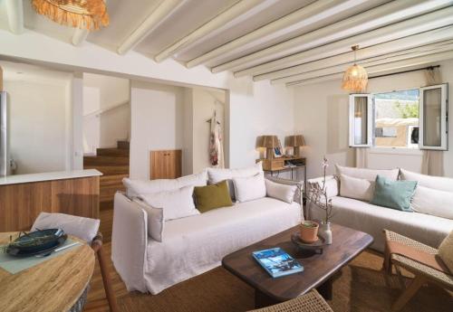 a living room with two couches and a table at Villa Astrofegia Moonlit Escape with Sea Views in Pachyammos