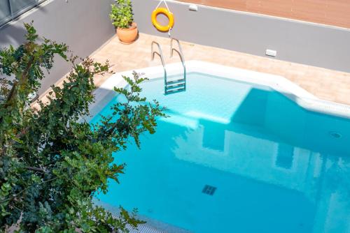 an overhead view of a swimming pool with a swing at DreamCoast Apartments I in Artemida