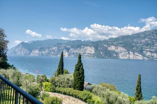 a view of a lake with trees and mountains at Villa Andreis in Malcesine