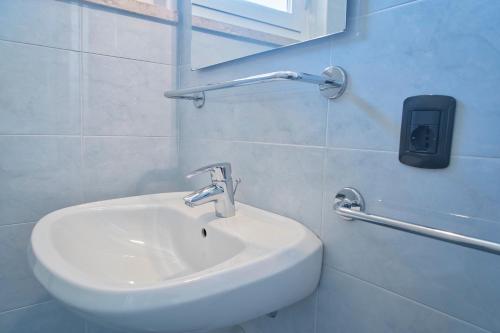 a bathroom with a white sink and a mirror at Villa Andreis in Malcesine