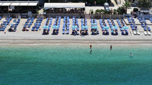 an aerial view of a beach with chairs and umbrellas at Sunny beach Jonufer in Vlorë