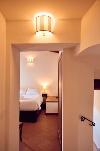 a hotel room with a bed and a hallway at Agriturismo Fattoria Poggio di Fiesole in Fiesole