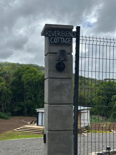 a fence with a sign for a river bend coffee at Eco Lodge Chamarel in Chamarel