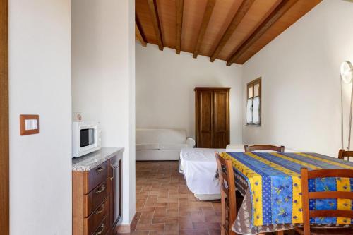 a room with a bed and a table with a microwave at La Bettola Tavern Rooms Restaurant in Montopoli in Val dʼArno