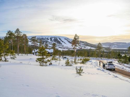 a car parked on a road in the snow at Stöten Mitt Lägenheter in Sälen