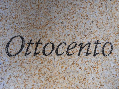 a close up of the word alcohol written on a floor at Ca' Ottocento in Lazise