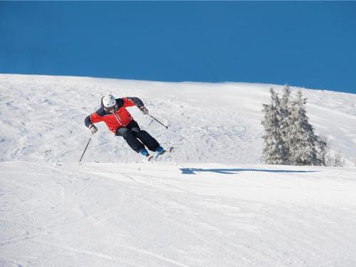 a person is skiing down a snow covered slope at Stöten Mitt Lägenheter in Sälen
