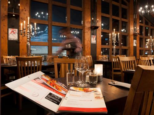 a table in a restaurant with a book on it at Stöten Mitt Lägenheter in Sälen
