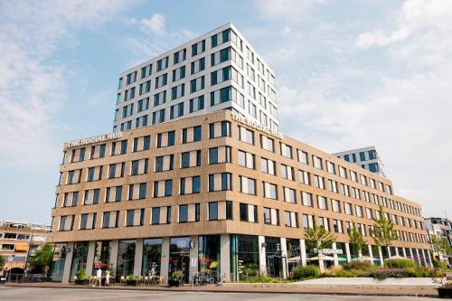a large office building in the middle of a street at The Social Hub Delft Extended Stay in Delft