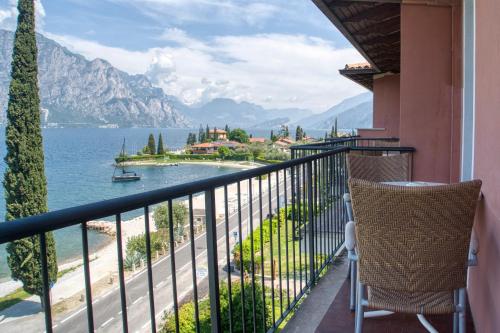 a balcony with a view of the water and mountains at Villa Andreis in Malcesine