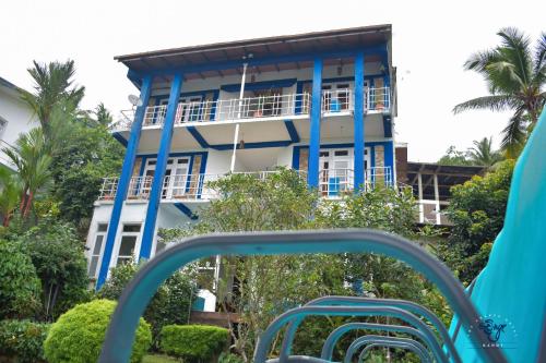 a blue and white building in front of a playground at The Change Hotel in Kandy