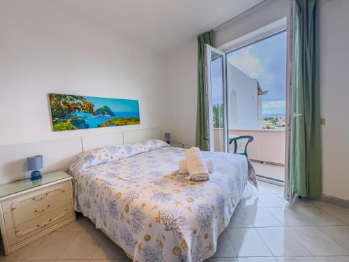 a bedroom with a bed and a large window at Av Club Terme Colella in Ischia