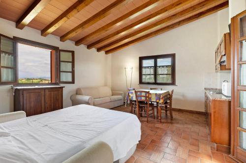 a bedroom with a bed and a table and chairs at La Bettola Tavern Rooms Restaurant in Montopoli in Val dʼArno