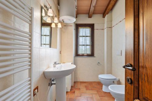 a bathroom with a sink and a toilet at La Bettola Tavern Rooms Restaurant in Montopoli in Val dʼArno
