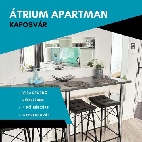Una cocina con mesa y taburetes con el texto apartamento de otoño kazajo en ÁTRIUM Apartman Kaposvár, en Kaposvár