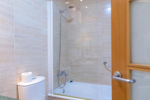 a bathroom with a shower with a toilet and a sink at Hotel Alda Xinzo in Xinzo de Limia