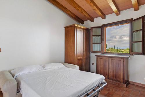 a bedroom with a bed and a window at La Bettola Tavern Rooms Restaurant in Montopoli in Val dʼArno