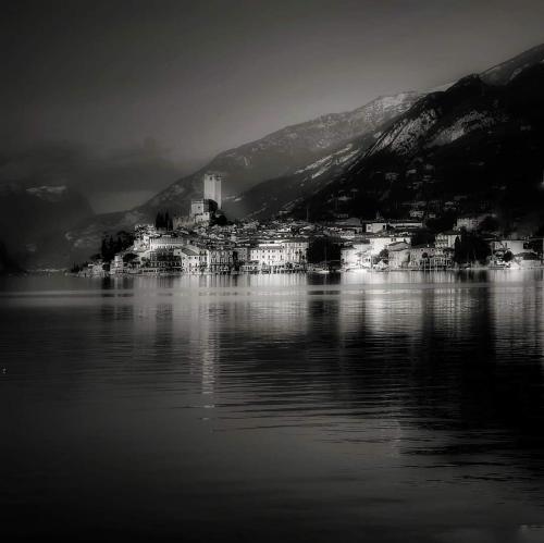 a black and white photo of a city on a lake at Locanda Monte Baldo in Malcesine