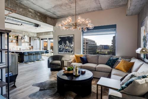 a living room with a couch and a table at Sable 501 - Luxury Two Story Loft in Minneapolis