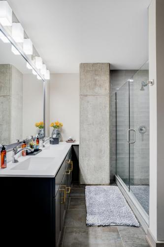 a bathroom with two sinks and a shower at Sable 501 - Luxury Two Story Loft in Minneapolis