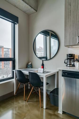 a kitchen with a table and two chairs and a mirror at Sable 606 - One Bedroom in Minneapolis