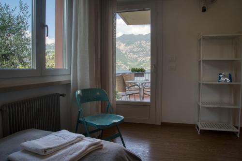 a bedroom with a bed and a window and a table at Villa Andreis in Malcesine