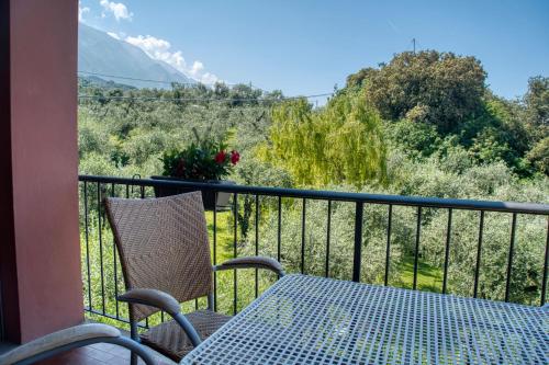 a table and chairs on a balcony with a view at Villa Andreis in Malcesine