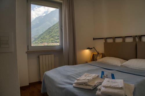 a bedroom with a bed and a window with towels on it at Villa Andreis in Malcesine
