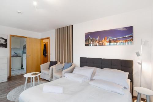 a white bed with white pillows in a room at Nette kompakte Wohnung mit Balkon in Pforzheim